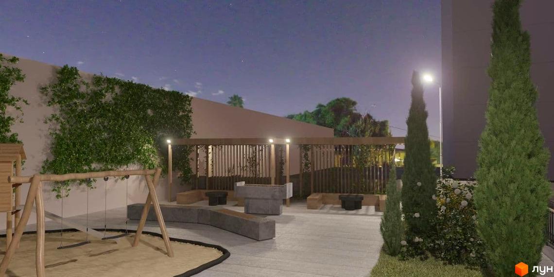 Вигляд на прибудинкову територію Житлового комплексу Затишний ввечері, що включає дитячий майданчик, зону відпочинку та зелені насадження.