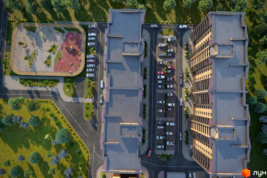 Вид зверху на житловий комплекс Лісовий New з фасадами будівель та прибудинковою територією з дитячим майданчиком та парковкою.