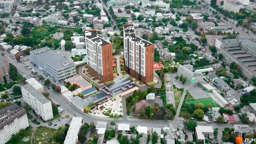 Новобудова Технопарк: два високі будинки з коричнево-білими фасадами та облаштованою прибудинковою територією з зеленими насадженнями.