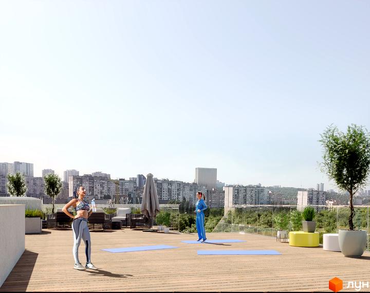 7 Avenue: вид на житловий комплекс з тераси для йоги. На терасі дві дівчини займаються спортом на фоні міського пейзажу.