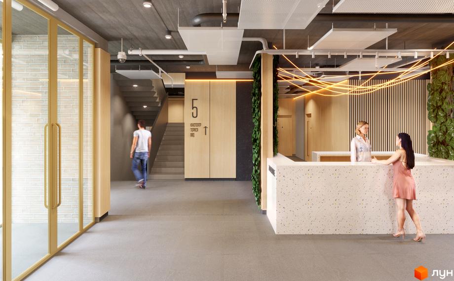 Сучасний дизайн холу житлового комплексу 7 Avenue з ресепшн та зоною очікування. На фото людина йде по коридору до сходів.