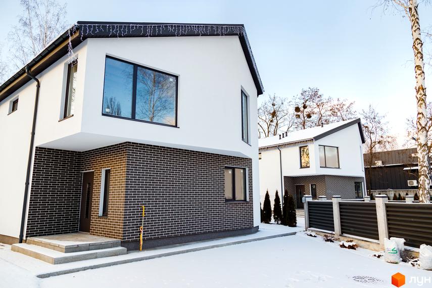 Котеджне містечко КМ Friends Club: двоповерхові будинки з білою та цегляною обробкою взимку, прибудинкова територія засніжена.