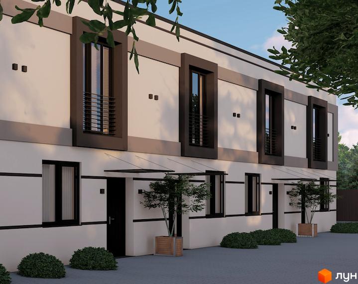 Фасад таунхаусів La Vie з великими вікнами та чорними рамами. На прибудинковій території дерева у вазонах та газон.