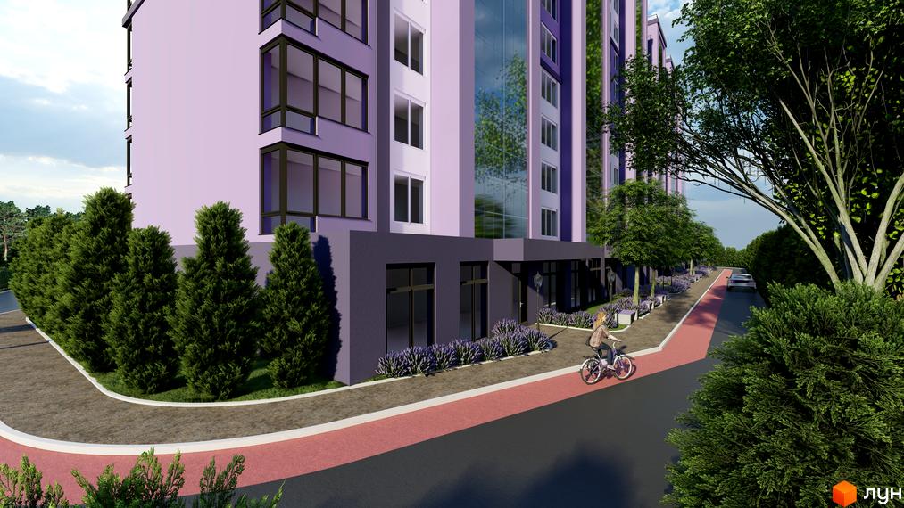 Зображення фасаду та прибудинкової території Житлового комплексу Колорит. На передньому плані пішохідна алея з велосипедисткою.