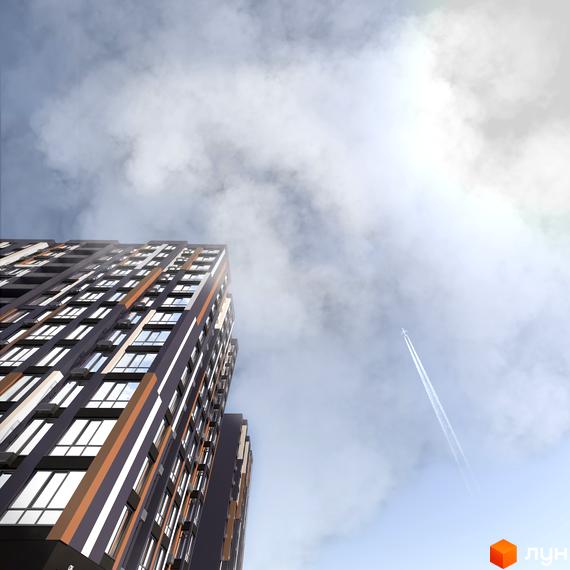 Житловий комплекс U One: високий багатоповерховий будинок з темно-сірими та помаранчевими фасадами, що тягнеться до хмарного неба з літаком.