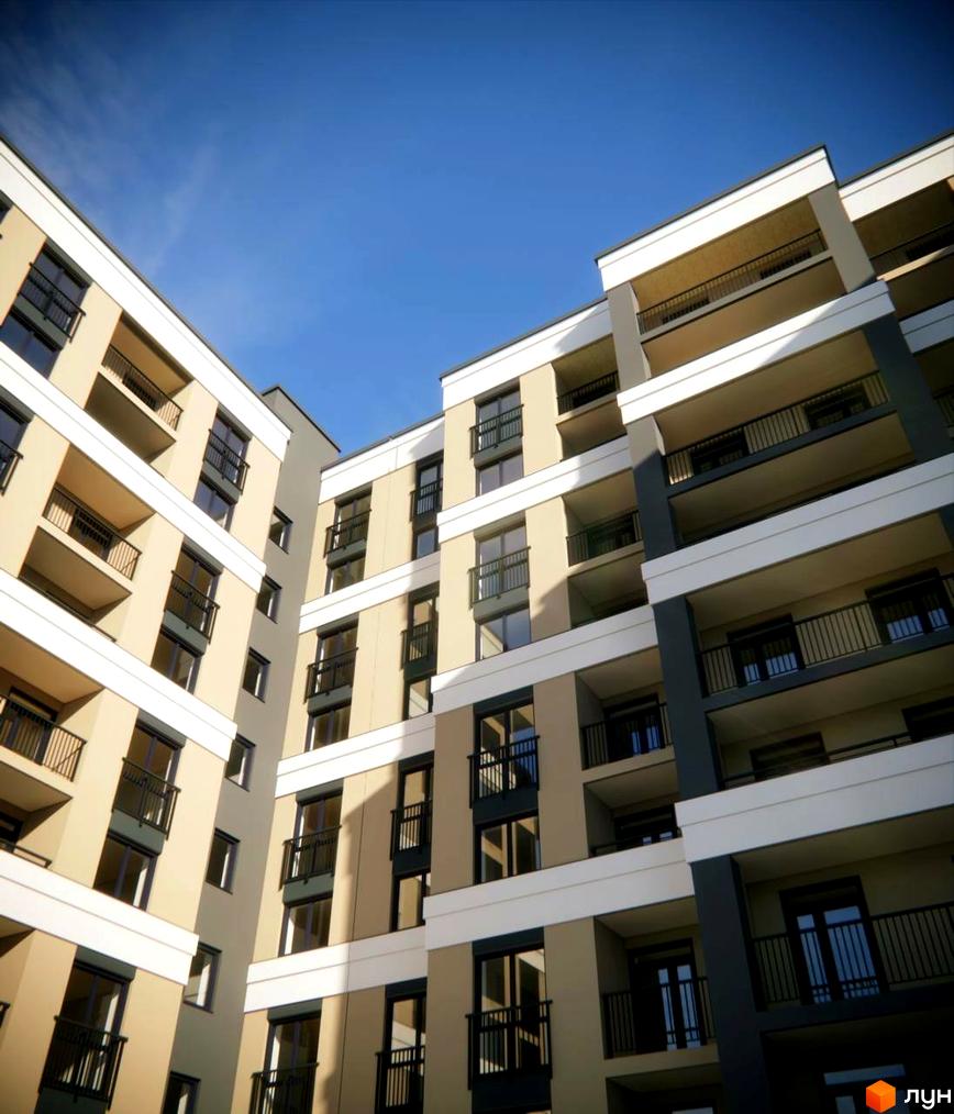 Багатоповерховий будинок Житлового комплексу Агора з бежевим фасадом, чорними балконами та вікнами, на фоні блакитного неба.