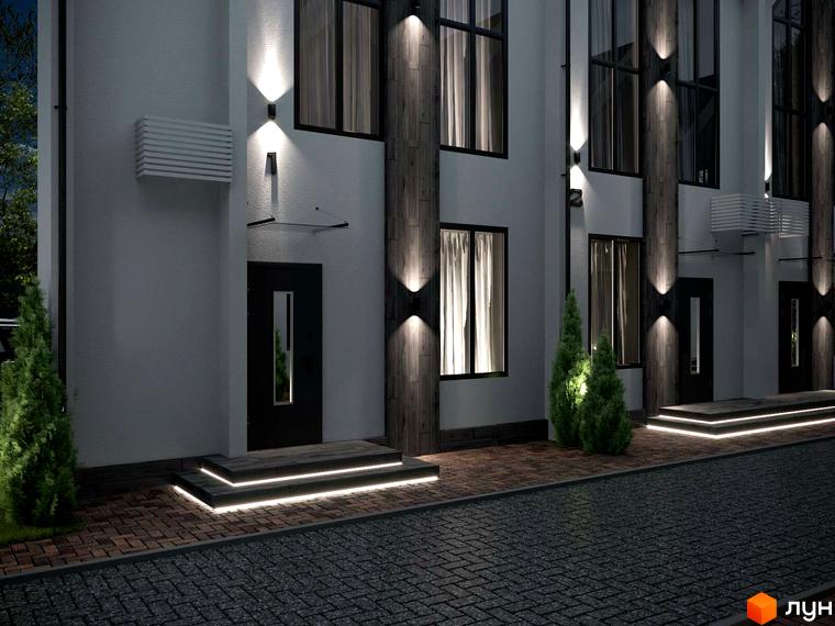Зовнішній вигляд таунхаусів IHOUSE VILLAGE з підсвіткою фасаду та бруківкою на території. Житловий комплекс має два поверхи та великі вікна.