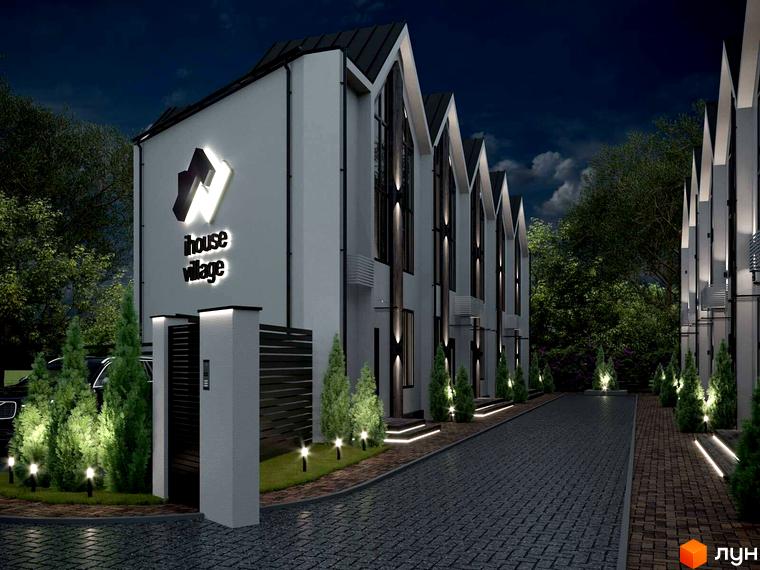 Нічний вигляд Таунхаусів IHOUSE VILLAGE з гострими дахами та світлими фасадами. Доріжки вимощені бруківкою, а територія освітлена ліхтарями та зеленими насадженнями.