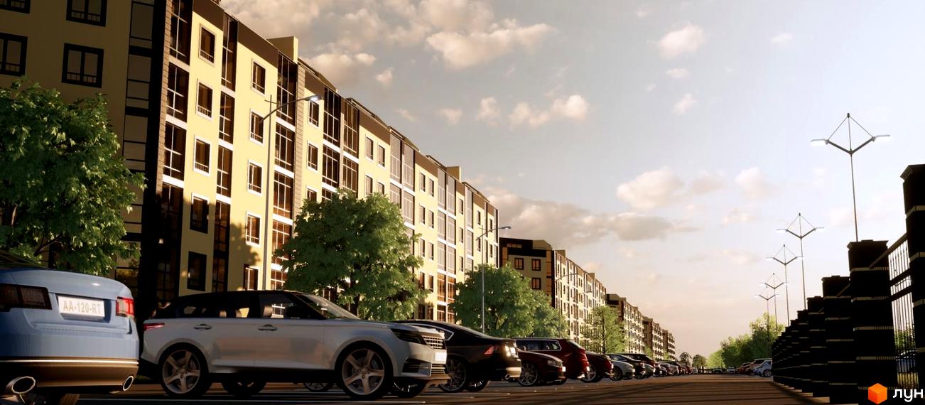 Зовнішній вигляд житлового комплексу Масив Європейський з автомобілями на парковці та освітленням. Сучасна архітектура та доглянута прибудинкова територія.