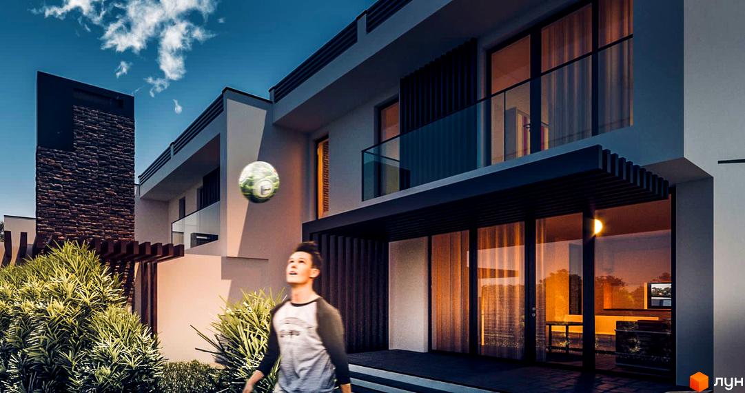 Таунхауси PANORAMA HILLS мають світлий фасад, великі вікна, балкон зі скляними поручнями та кам'яну вежу. Прибудинкова територія озеленена, на ній грає хлопчик з м'ячем.