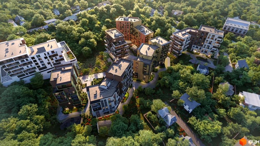 Аерофотозйомка житлового комплексу Goloseev Hills з багатьма будинками різної поверховості, оточеними зеленню та деревами. На території комплексу видно доглянуті доріжки та зелені зони.
