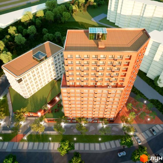 Вид зверху на Житловий комплекс на Величковського: багатоповерховий будинок з червоної цегли та прибудинкова територія з дитячим майданчиком.