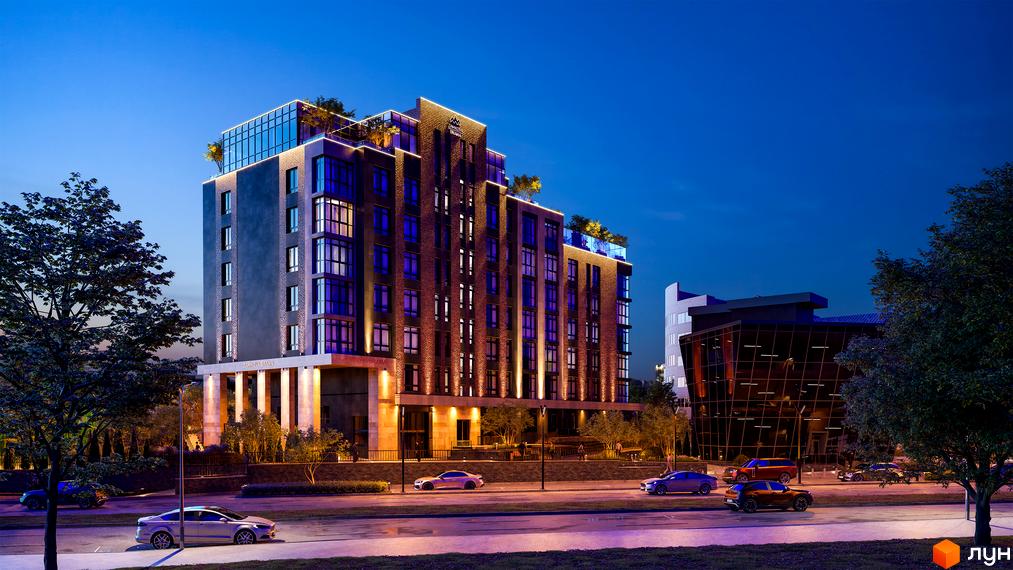 Зображення фасаду Житлового комплексу Замкова Брама вночі. Навколо будинку видно дерева, дорогу та припарковані автомобілі.