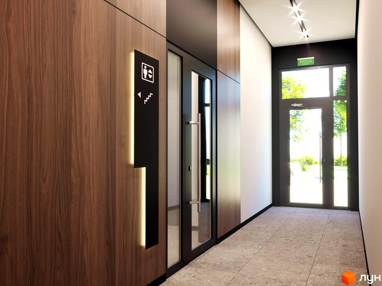 Сучасний вхід до житлового комплексу Бетховен з дерев'яними панелями та дверима назовні. На стіні видно покажчик до ліфта та сходів.