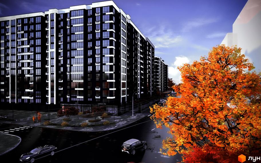 Новобудова Comfort Park з темним фасадом та білими елементами. Поруч дорога з автомобілями та дерево з жовтим листям.