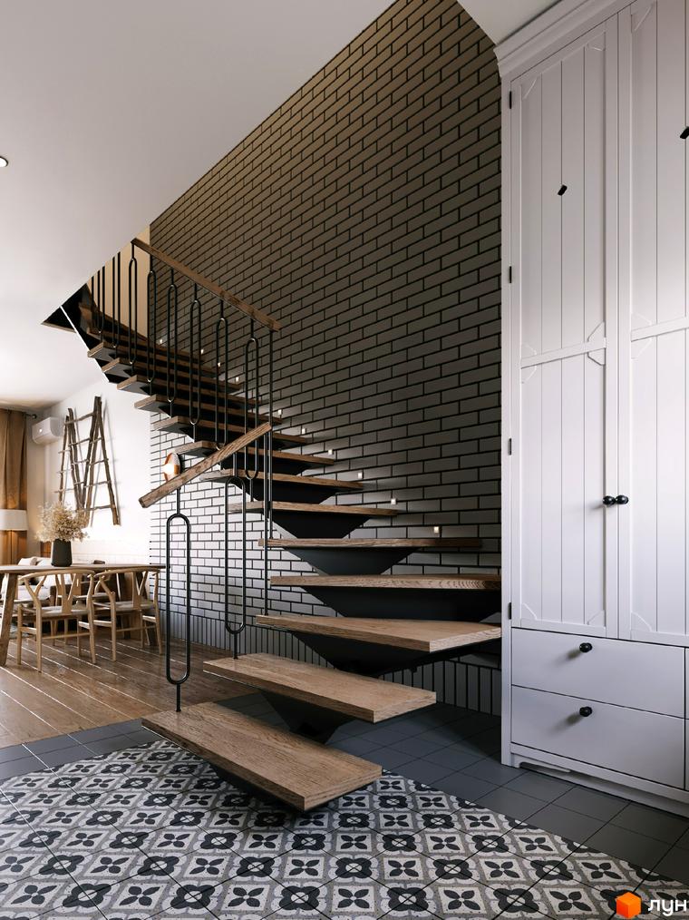 Сходи в будинку житлового комплексу AMA FAMILY RESORT з цегляною стіною та білими шафами. Інтер'єр у світлих тонах з дерев'яними елементами.