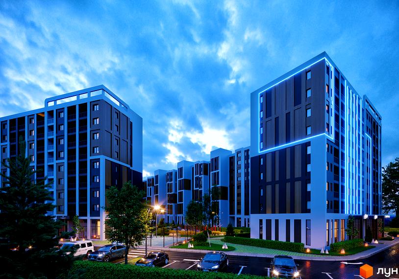 Житловий комплекс КЕЛЬЦЕ з підсвіченими фасадами та парковкою біля будівель. На території є дерева та спортивний майданчик.