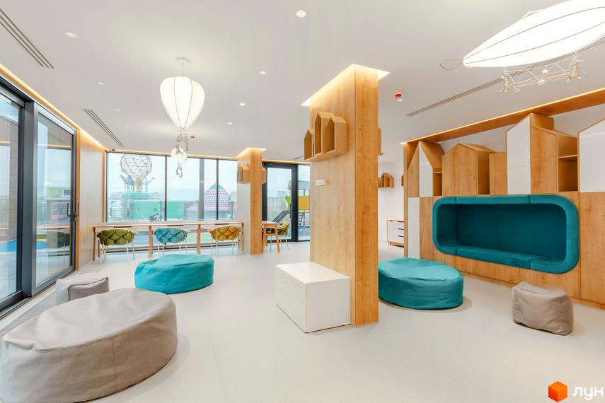 Інтер'єр дитячої кімнати в ЖК Obolon Plaza з м'якими пуфами та ігровою зоною. Сучасний дизайн простору для дітей.