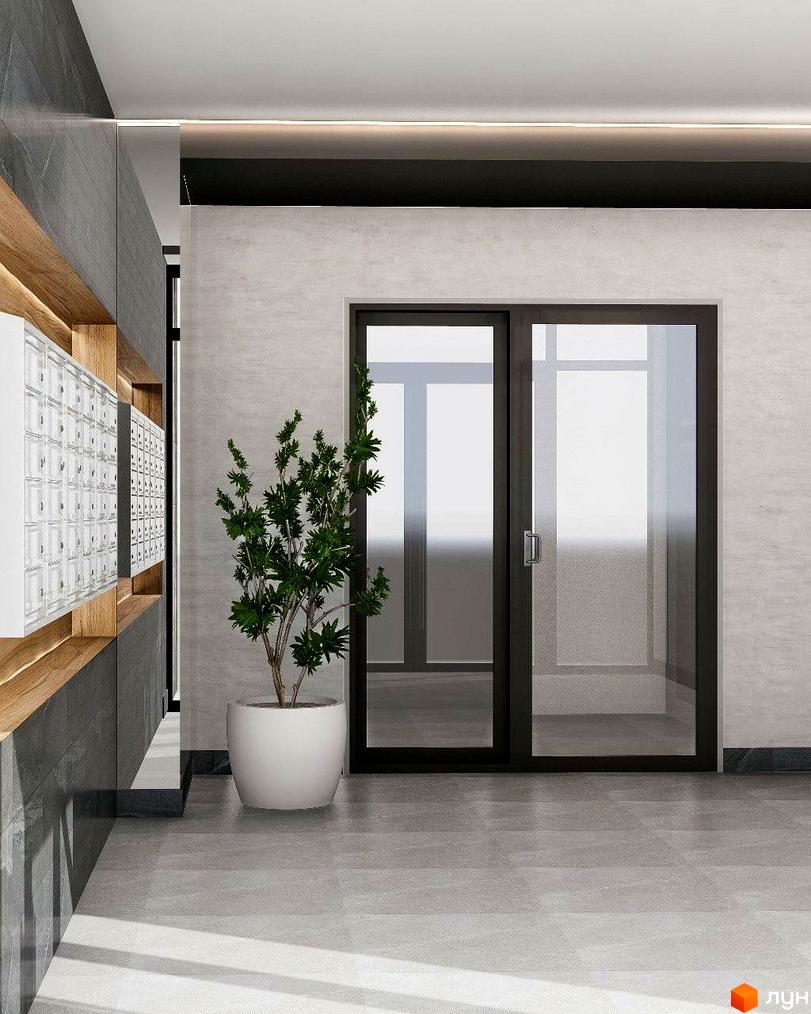 Вхідна група в ЖК Науковий з великими скляними дверима, рослиною в горщику та поштовими скриньками.