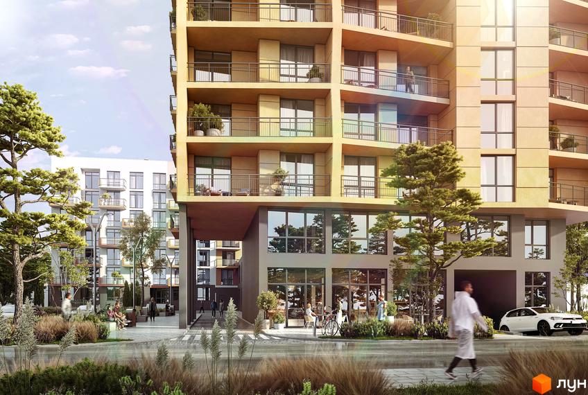 Житловий комплекс AUROOM SPARK з жовтим фасадом та балконами, поруч біла будівля та зелені дерева. На прибудинковій території є люди та автомобіль.