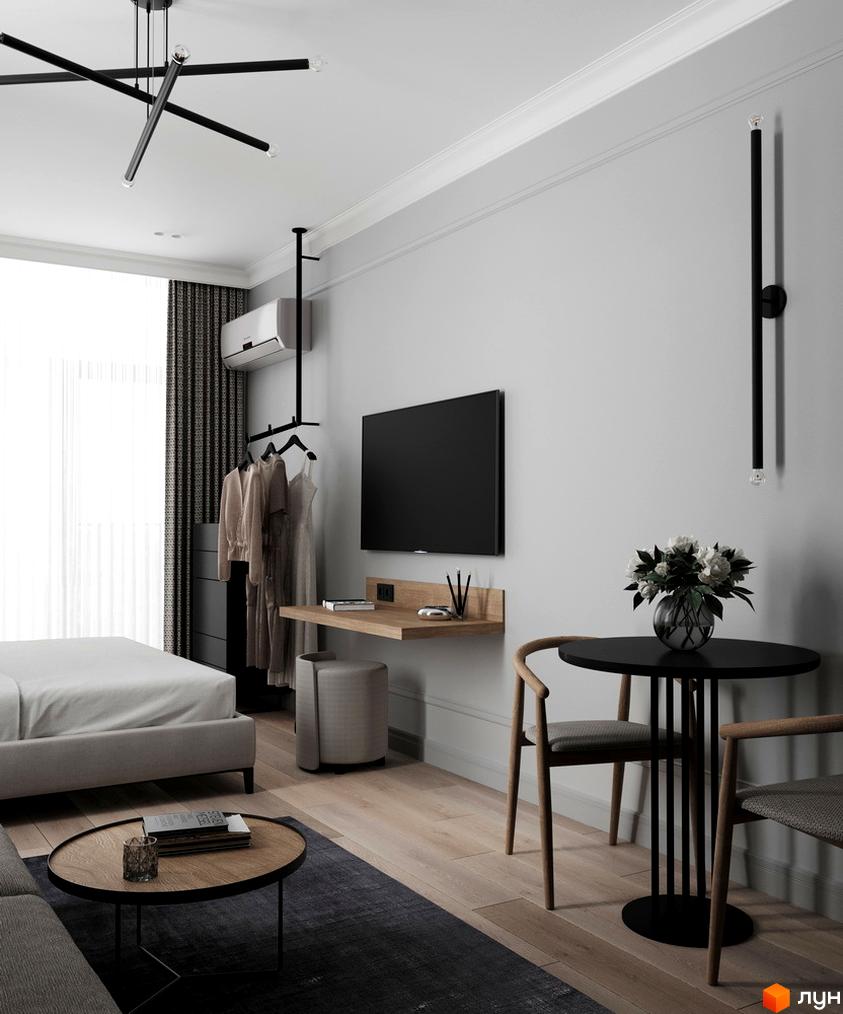 Апарт-готель PRAUD select: стильний інтер'єр номера з ліжком, столиком, телевізором та кріслами. Сучасний дизайн та функціональне планування для комфортного проживання.