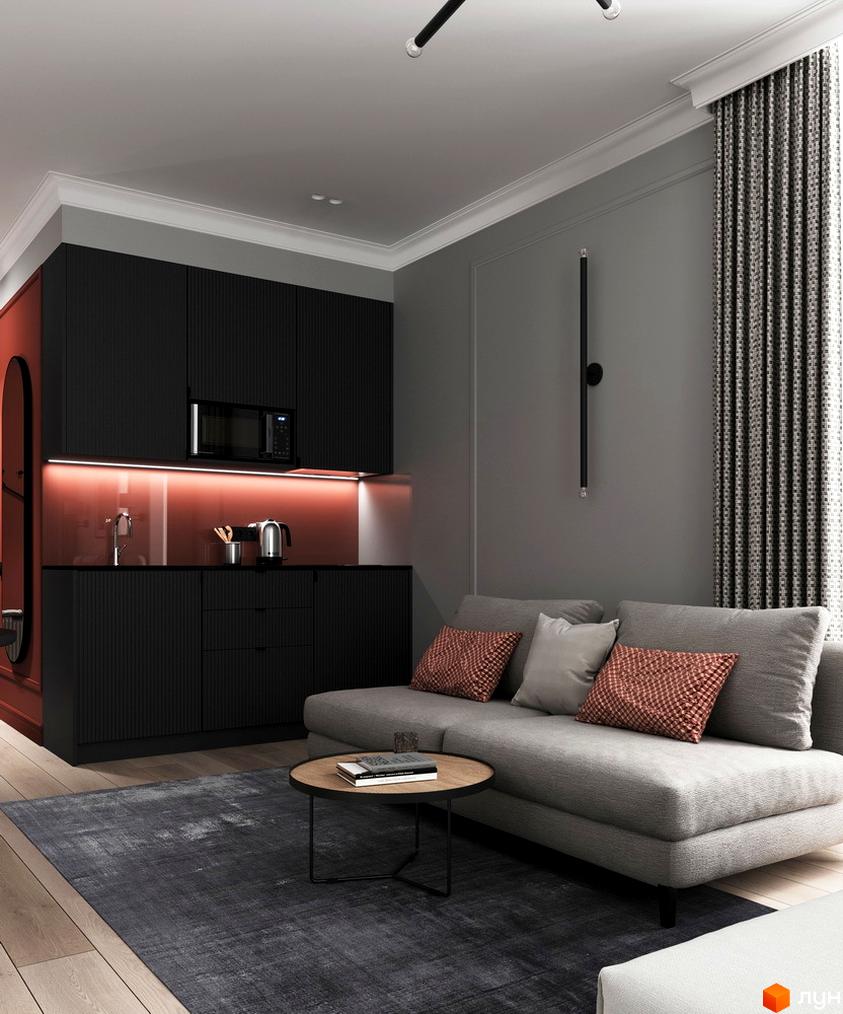 Інтер'єр апарт-готелю PRAUD select: кухня з чорними фасадами та червоною підсвіткою, сірий диван з декоративними подушками, журнальний столик, темний килим.