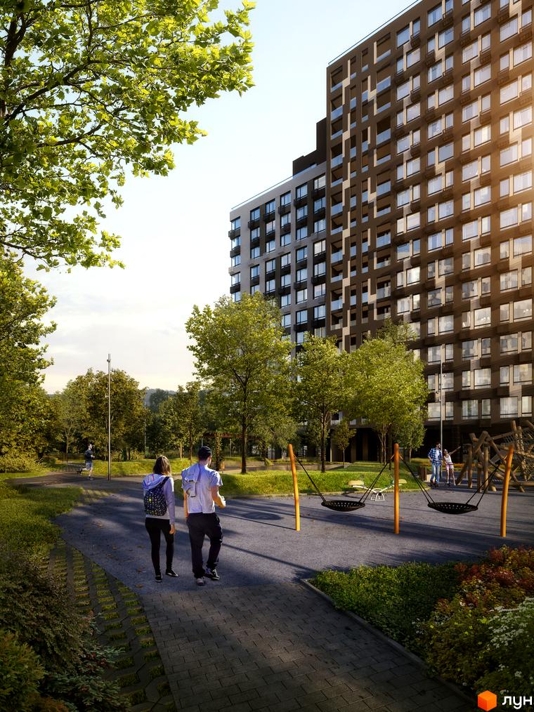 Висотна будівля житлового комплексу А+Я з великими вікнами. На передньому плані доріжка, дитячий майданчик та зелені насадження.