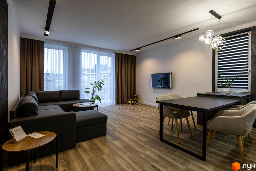 Інтер'єр вітальні з диваном та обідньою зоною в ЖК Струмочок 2. Простора кімната з великими вікнами та сучасним освітленням.