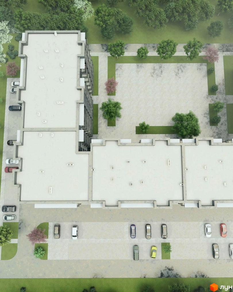 Вид зверху на житловий комплекс Мала Прага з паркуванням та зеленими насадженнями. Будинок має плаский дах та багатоповерхову структуру.