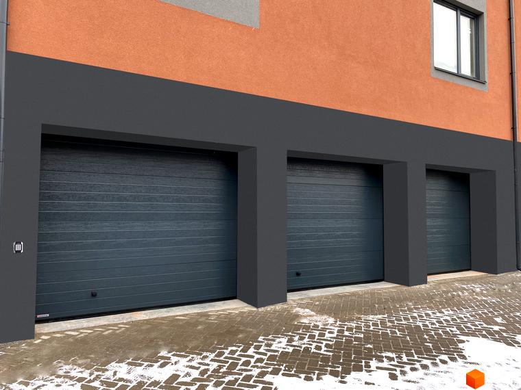 Три гаражні ворота в сучасному будинку з помаранчевою штукатуркою та сірою обробкою. Перед воротами бруківка з залишками снігу.