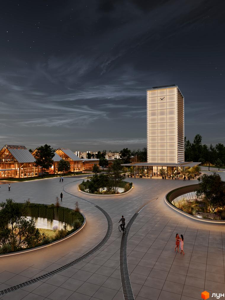 Нічна панорама житлового комплексу Vlasne Misto з високою освітленою вежею та кількома одноповерховими будівлями з дерев'яними елементами. Навколо - доглянута територія з водоймами та пішохідними доріжками.