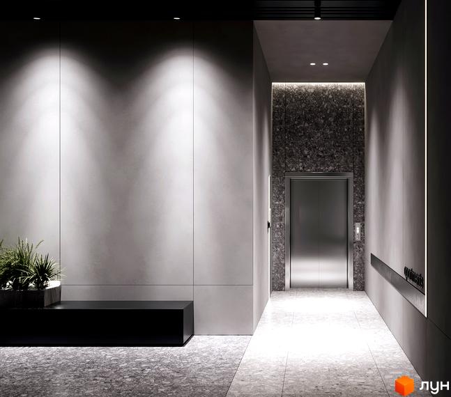 Сучасний вхід до житлового комплексу MARVEL Hill з ліфтом та оздобленням стін під камінь. Освітлення створює затишну атмосферу.