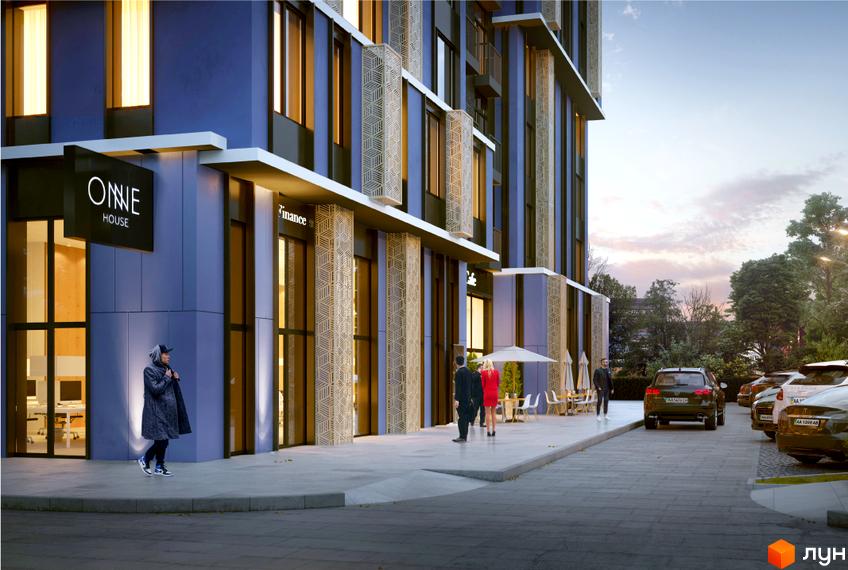 Житловий комплекс One House з синім фасадом та великими вікнами. Перед будинком вимощена територія з вуличними кафе та парковкою для автомобілів.