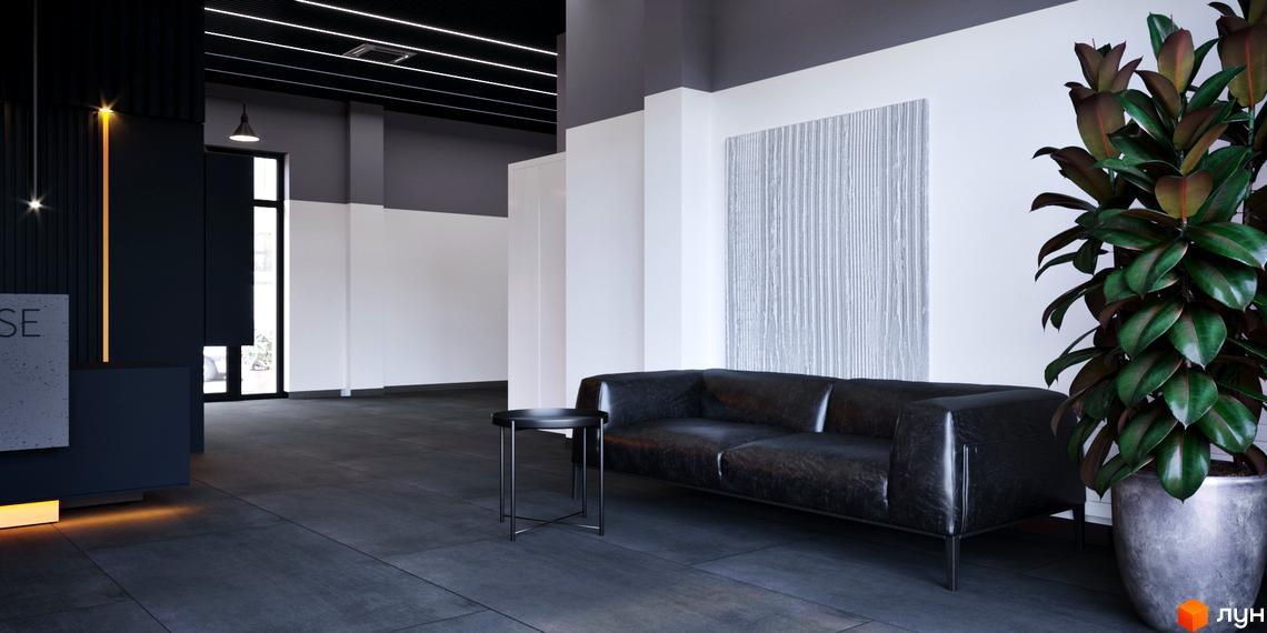 Лобі Житлового комплексу One House: зона відпочинку з чорним диваном, декоративним освітленням та великою рослиною у вазоні.