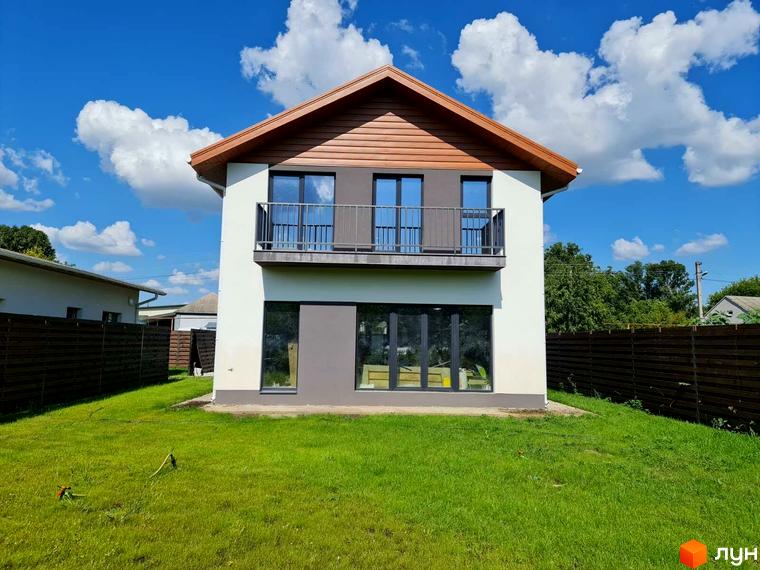 Котеджне містечко КМ Заміський: двоповерховий будинок з балконом та великими вікнами, зелена галявина та паркан.
