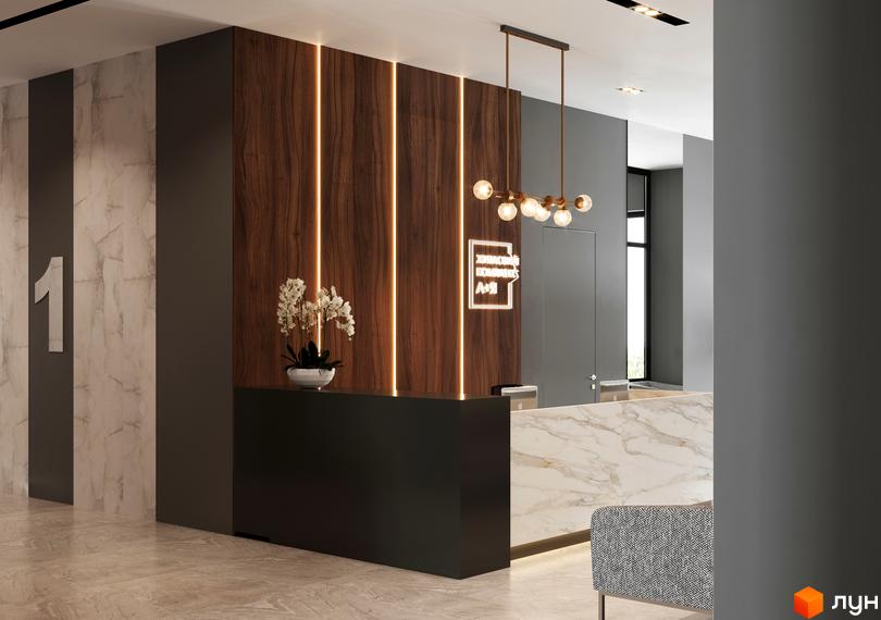 Інтер'єр холу в Будівельному проєкті A+Я з оздобленням деревом та мармуром. На стіні велика цифра 1 та логотип комплексу.