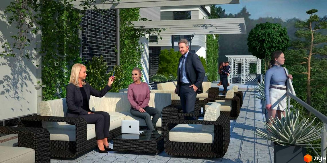 Котеджне містечко Alabama Cottage Town. Люди відпочивають на терасі з видом на зелені насадження та місто.