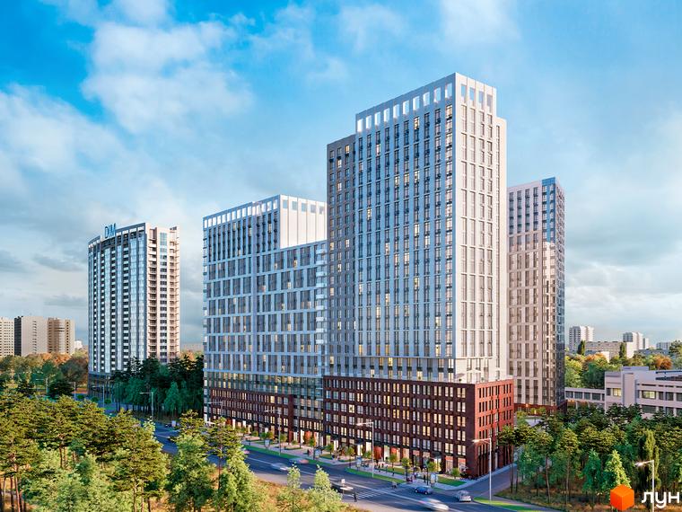 Зовнішній вигляд житлового комплексу Новий Автограф з високими будівлями та прибудинковою територією з деревами та дорогою.