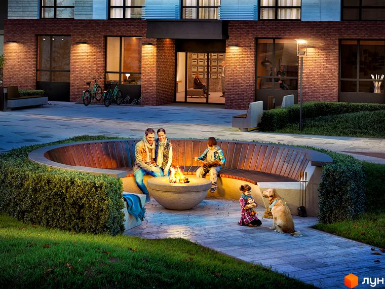 Житловий комплекс Новий Автограф: сімейна зона відпочинку з каміном та зонами для сидіння на прибудинковій території.