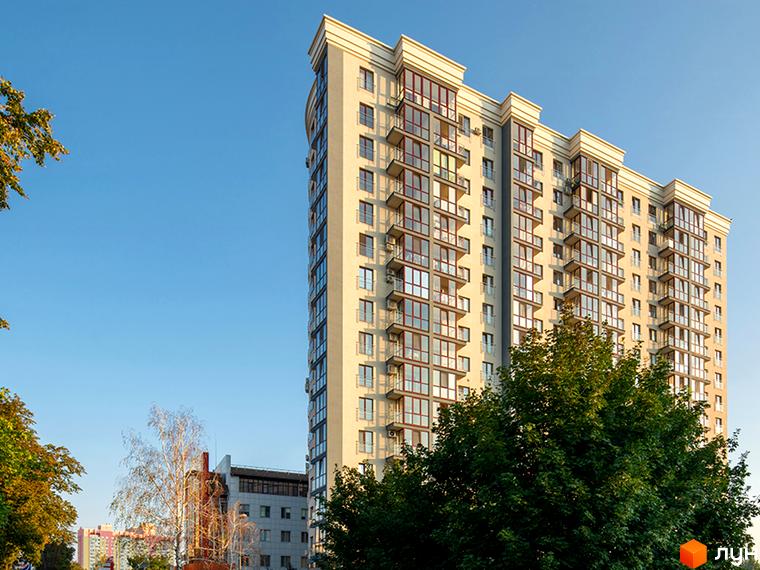 Фамільний – висотна новобудова з численними балконами та панорамними вікнами. Навколо комплексу зелені дерева та блакитне небо.