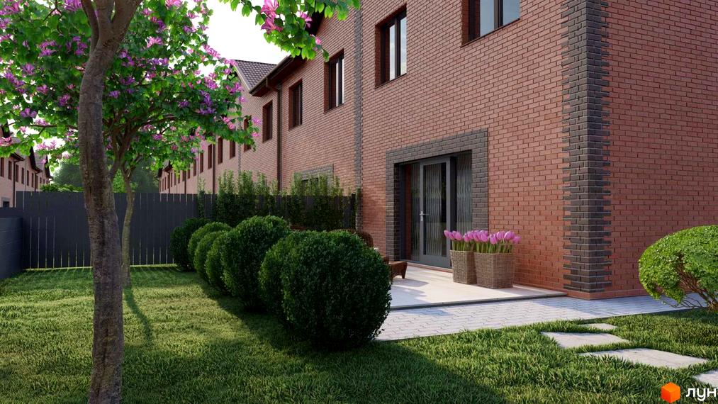 Вигляд будинку в Котеджному містечку Екологічне з прибудинковою територією. На подвір'ї зелений газон, кущі та дерева з рожевими квітами.