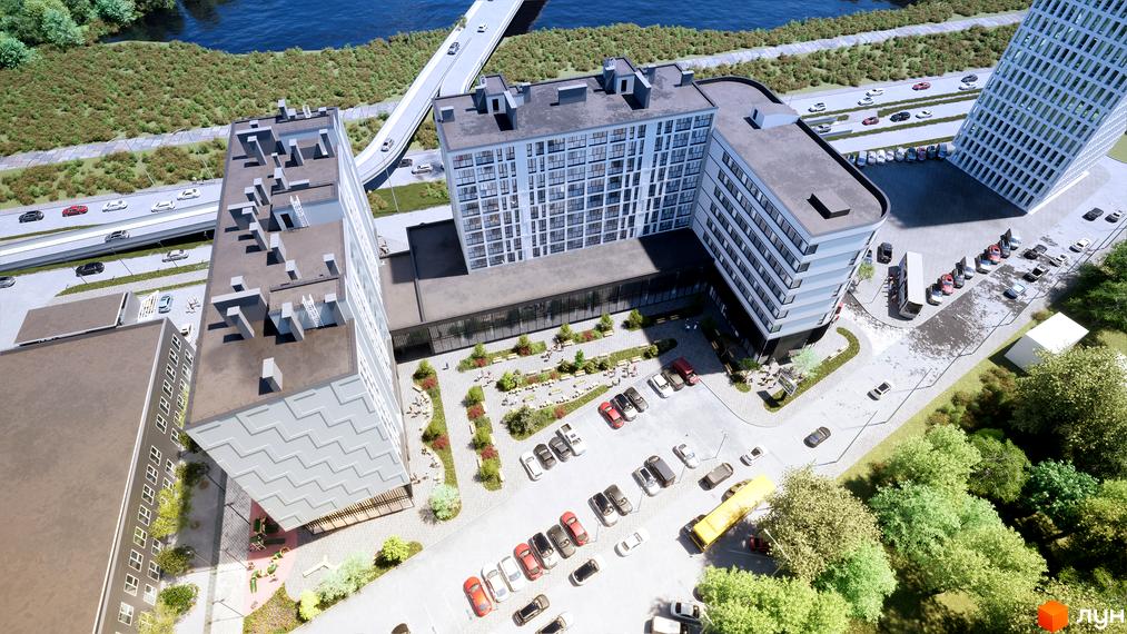 Зображення Житлового комплексу Kniahynyn-Center з висоти пташиного польоту, видно будівлю та прибудинкову територію з паркінгом.