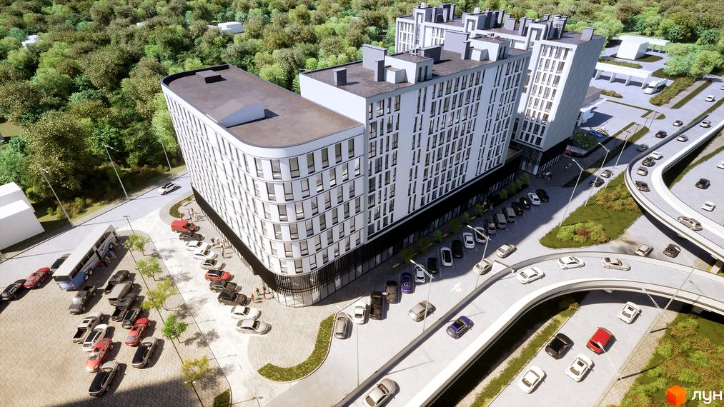 Житловий комплекс Kniahynyn-Center з білими фасадами та панорамними вікнами, оточений зеленню та дорогою з автомобілями.