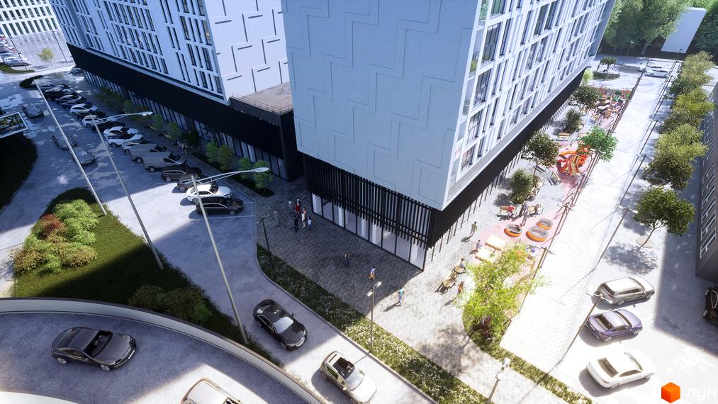 Житловий комплекс Kniahynyn-Center з автомобілями на парковці та дитячим майданчиком. Зовнішній вигляд новобудови та прибудинкова територія.