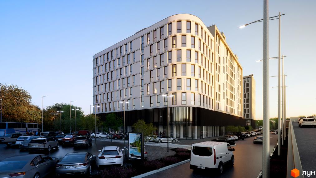 Будівельний проєкт Kniahynyn-Center з вигнутим фасадом та великою кількістю вікон. Навколо новобудови розташована парковка з автомобілями та вуличне освітлення.