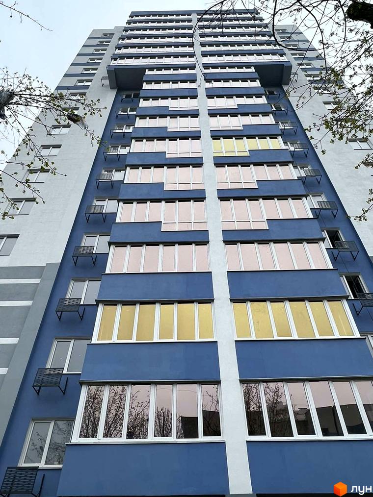 Зовнішній вигляд новобудови ЖК Diamond Hall з синім фасадом та великою кількістю вікон. Будинок має багатоповерхову структуру з виступаючими елементами.