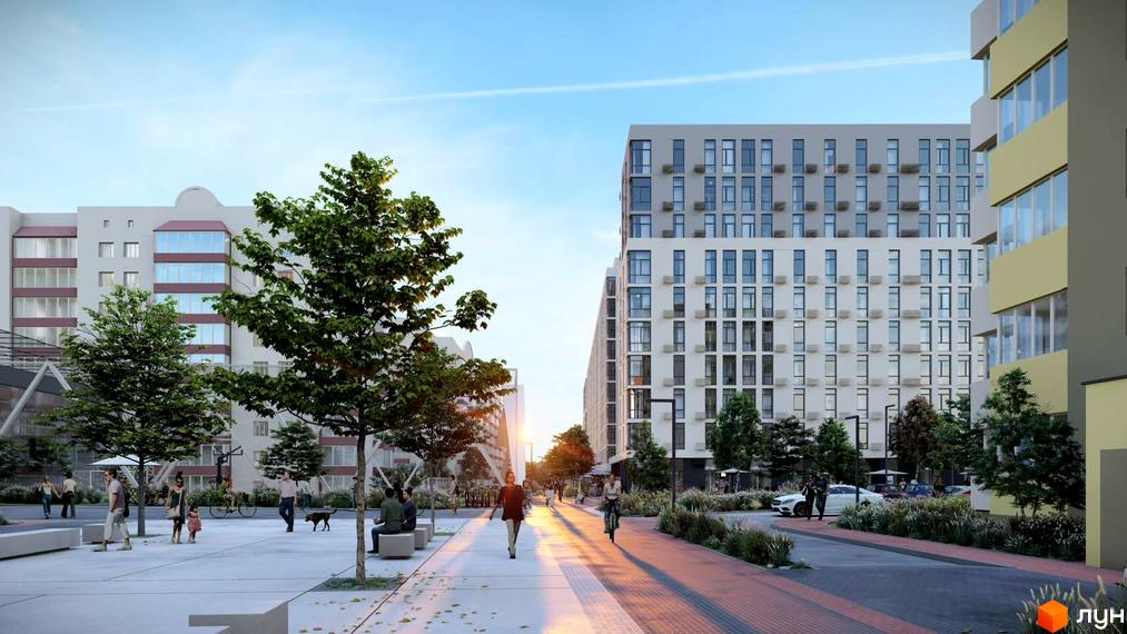 Житловий комплекс Обухівський ключ. Високі будинки з великою кількістю вікон. На території комплексу є дерева, тротуари та місця для відпочинку.