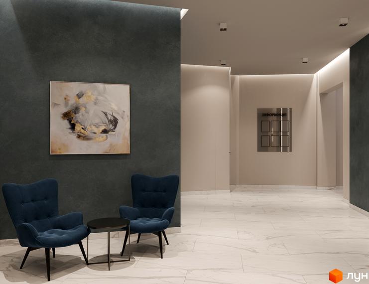 Інтер'єр холу в ЖК Посейдон. Простір з м'якими кріслами та картиною на стіні, оздоблений світлим мармуром.