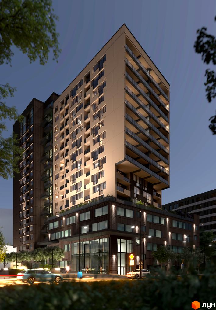 Житловий комплекс AUROOM AIR з фасадами з підсвіткою та балконами, що виступають, на тлі нічного неба. Навколо будівлі розташовані дерева та освітлені вулиці з автомобілями.