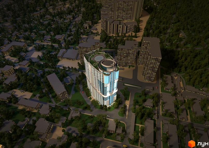 Вид на житловий комплекс Новий берег з висоти пташиного польоту. Овальна будівля з блакитними вікнами та зеленою зоною на даху. Навколо комплексу розташовані інші будівлі та дерева.